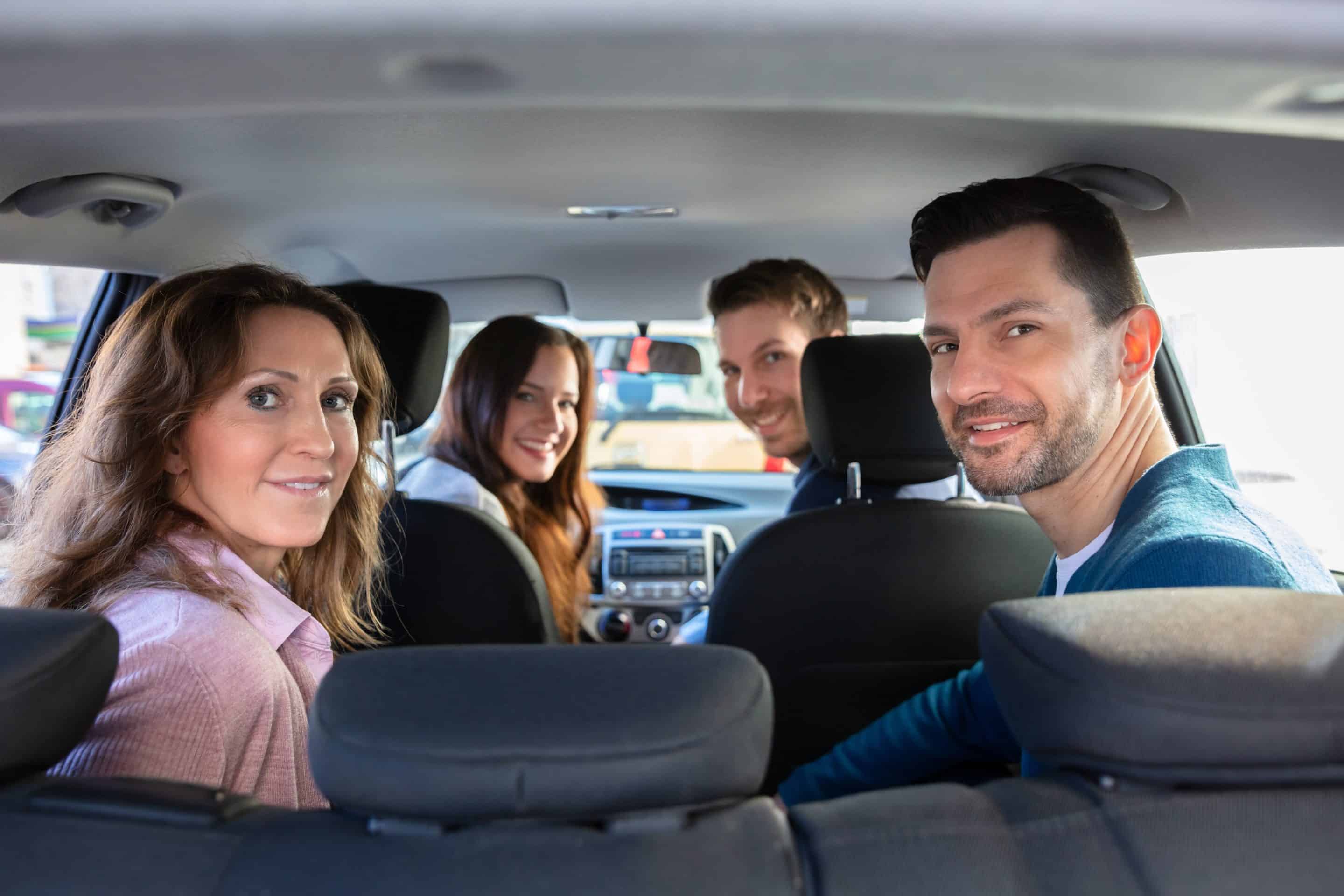 Smiling People Sitting Inside The Ride Sharing Car